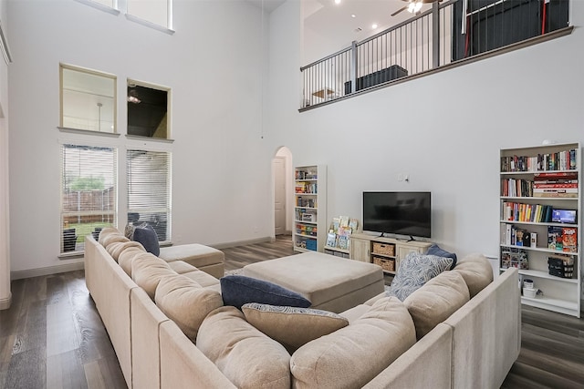 12959 Averi Ln, Farmers Branch, TX 75234 - living area with a high ceiling, arched walkways, wood finished floors, a ceiling fan, and baseboards