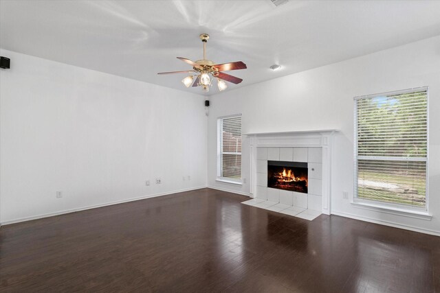 5919 Wisdom Creek Dr, Dallas, TX 75249 - unfurnished living room featuring a ceiling fan, a fireplace, wood finished floors, and baseboards