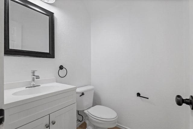 5919 Wisdom Creek Dr, Dallas, TX 75249 - half bath featuring vanity, toilet, and baseboards