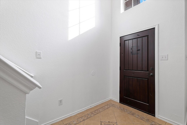 5919 Wisdom Creek Dr, Dallas, TX 75249 - entryway with baseboards, light tile patterned floors, and inlaid floor details