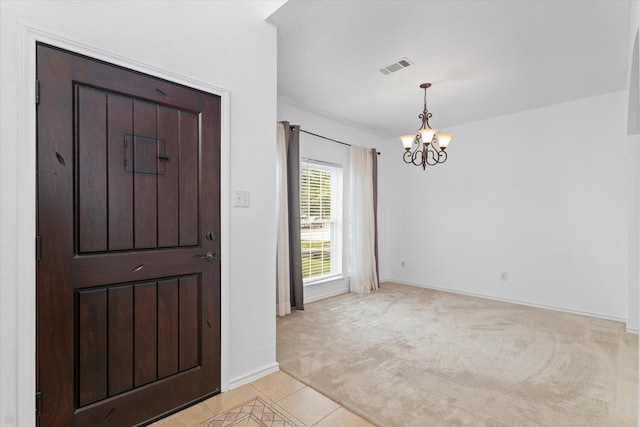 5919 Wisdom Creek Dr, Dallas, TX 75249 - foyer entrance featuring a chandelier, light colored carpet, light tile patterned floors, and baseboards