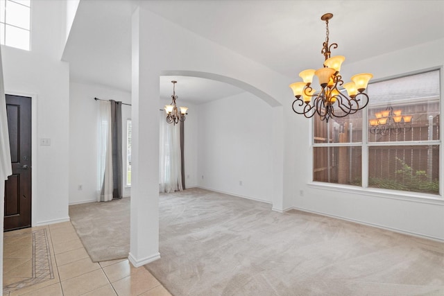 5919 Wisdom Creek Dr, Dallas, TX 75249 - tiled entryway featuring a chandelier, arched walkways, carpet, and baseboards