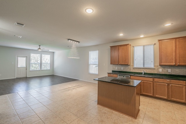 2409 Buelingo Ln, Fort Worth, TX 76131 - kitchen featuring a sink, dishwasher, light tile patterned floors, a center island, and a ceiling fan