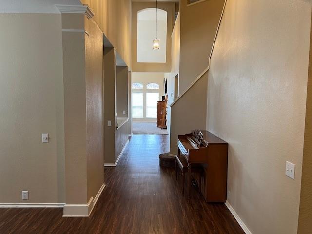 1275 Calistoga Dr, Rockwall, TX 75087 - hall featuring wood finished floors, baseboards, and stairway