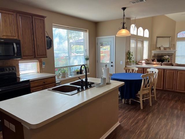 1275 Calistoga Dr, Rockwall, TX 75087 - kitchen with black appliances, a sink, dark wood finished floors, and healthy amount of natural light