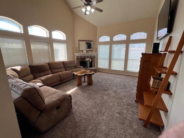 1275 Calistoga Dr, Rockwall, TX 75087 - living room with a ceiling fan, a fireplace, carpet floors, and high vaulted ceiling