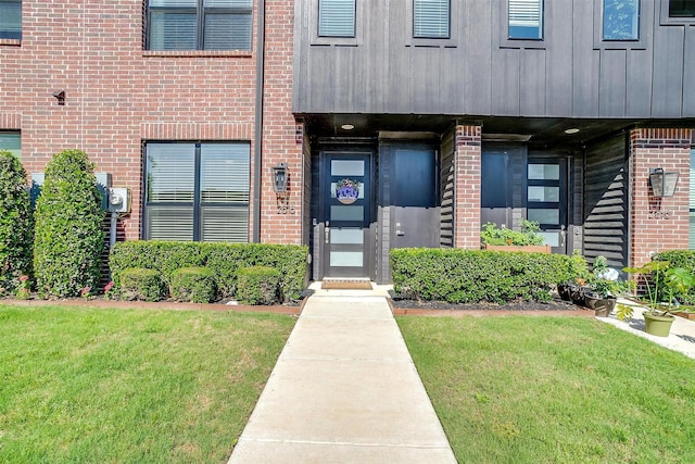 2818 Addison Park Ln, Fort Worth, TX 76110 - doorway to property featuring brick siding and a yard