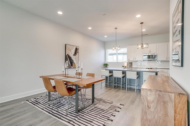 2818 Addison Park Ln, Fort Worth, TX 76110 - dining space featuring light wood-type flooring, recessed lighting, a chandelier, and baseboards