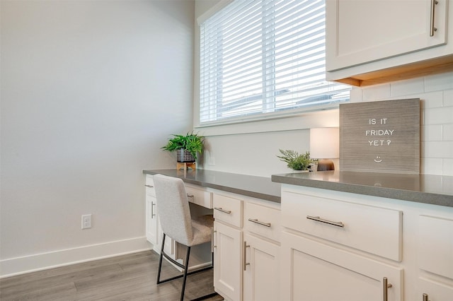 2818 Addison Park Ln, Fort Worth, TX 76110 - home office with built in study area, wood finished floors, and baseboards