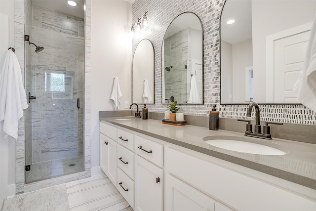 2818 Addison Park Ln, Fort Worth, TX 76110 - bathroom with a marble finish shower, recessed lighting, double vanity, and decorative backsplash