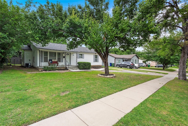 3532 Haltom Rd, Haltom City, TX 76117 - view of front of property featuring covered porch, central air condition unit, a front yard, and a shingled roof