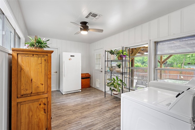 3532 Haltom Rd, Haltom City, TX 76117 - washroom featuring separate washer and dryer, ceiling fan, and light wood-style floors