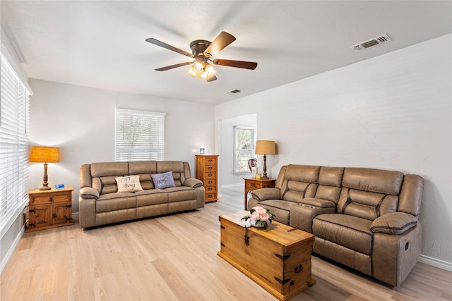3532 Haltom Rd, Haltom City, TX 76117 - living area featuring light wood-type flooring, ceiling fan, and baseboards