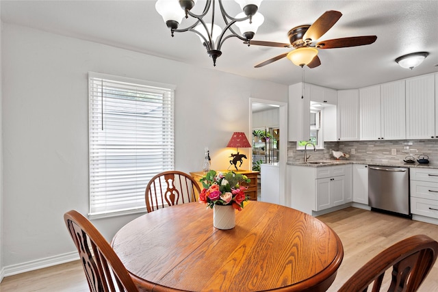 3532 Haltom Rd, Haltom City, TX 76117 - dining space with light wood finished floors, ceiling fan, baseboards, and a chandelier