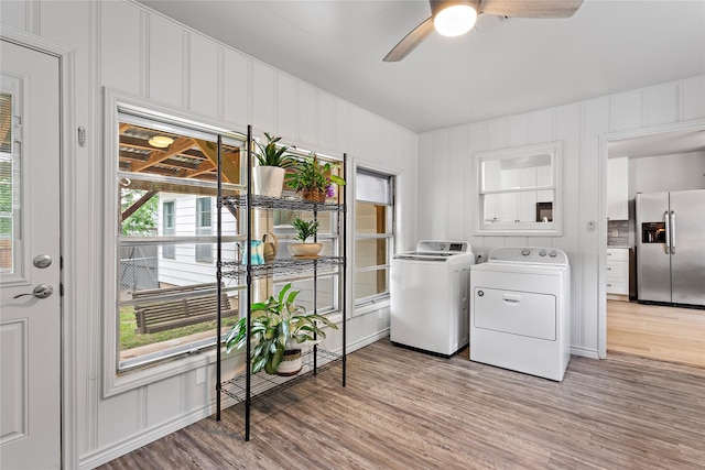 3532 Haltom Rd, Haltom City, TX 76117 - laundry area with separate washer and dryer, light wood-style floors, a ceiling fan, and a decorative wall