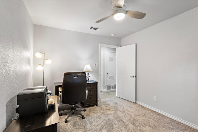 3532 Haltom Rd, Haltom City, TX 76117 - home office with light carpet, baseboards, a ceiling fan, and a textured wall