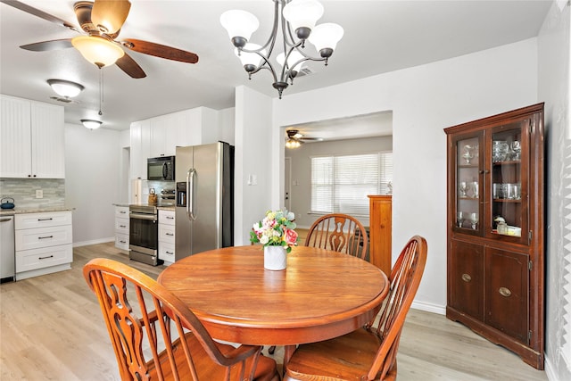 3532 Haltom Rd, Haltom City, TX 76117 - dining space with light wood finished floors, a ceiling fan, and a chandelier