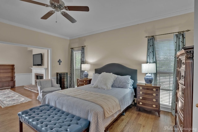 23 Tealwood, Shreveport, LA 71104 - bedroom featuring crown molding, wood finished floors, a fireplace, and a ceiling fan