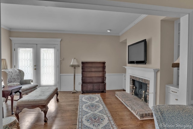 23 Tealwood, Shreveport, LA 71104 - living room with ornamental molding, a brick fireplace, wood finished floors, and a wainscoted wall