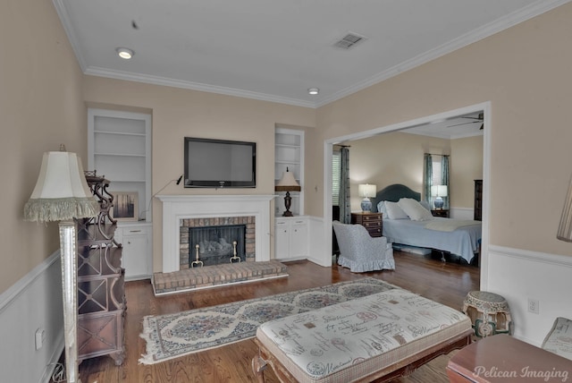23 Tealwood, Shreveport, LA 71104 - living area featuring built in shelves, wood finished floors, ornamental molding, and a brick fireplace