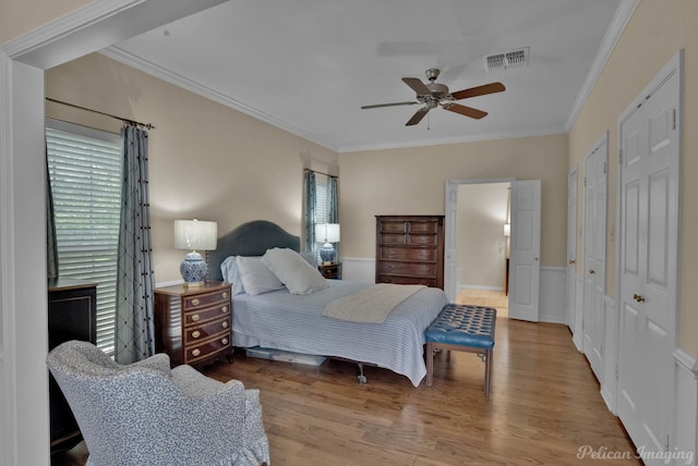 23 Tealwood, Shreveport, LA 71104 - bedroom with multiple windows, crown molding, wood finished floors, two closets, and wainscoting