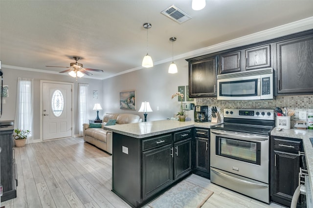 339 W Trinity St, Forney, TX 75126 - kitchen featuring stainless steel appliances, a peninsula, ceiling fan, light countertops, and ornamental molding