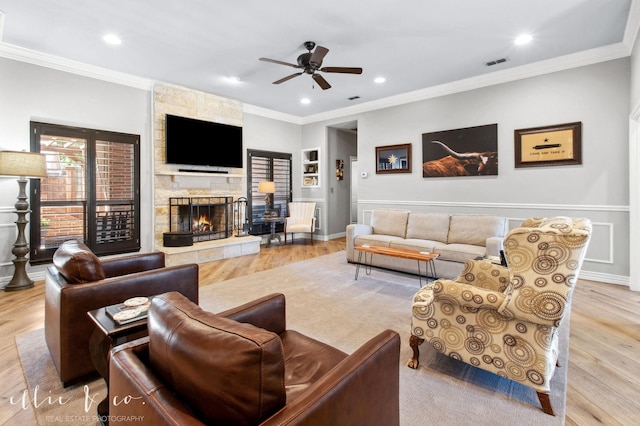 2409 Lynbrook Dr, Abilene, TX 79606 - living room with wood finished floors, ornamental molding, a ceiling fan, a stone fireplace, and recessed lighting