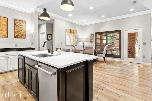 2409 Lynbrook Dr, Abilene, TX 79606 - kitchen with a sink, stainless steel dishwasher, ornamental molding, light wood-style floors, and decorative light fixtures