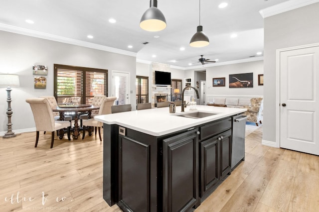 2409 Lynbrook Dr, Abilene, TX 79606 - kitchen featuring a sink, open floor plan, a large fireplace, crown molding, and ceiling fan
