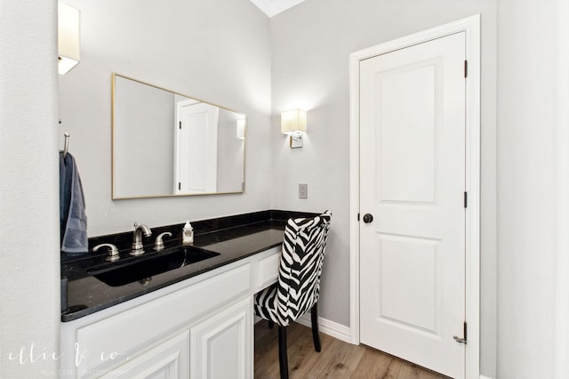 2409 Lynbrook Dr, Abilene, TX 79606 - bathroom with wood finished floors, baseboards, and vanity