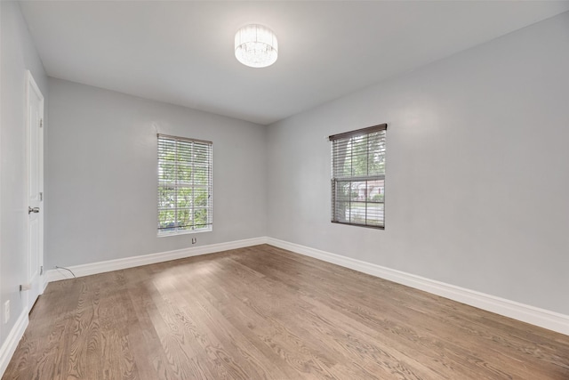317 Edgefield Dr, Garland, TX 75040 - spare room with wood finished floors, baseboards, and a chandelier