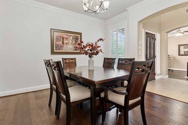 269 Love Bird Ln, Murphy, TX 75094 - dining space featuring a chandelier, arched walkways, crown molding, dark wood finished floors, and baseboards