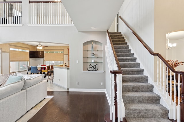 269 Love Bird Ln, Murphy, TX 75094 - stairs featuring hardwood / wood-style floors, a ceiling fan, baseboards, and a chandelier