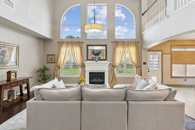 269 Love Bird Ln, Murphy, TX 75094 - living room with plenty of natural light, a high ceiling, and a glass covered fireplace