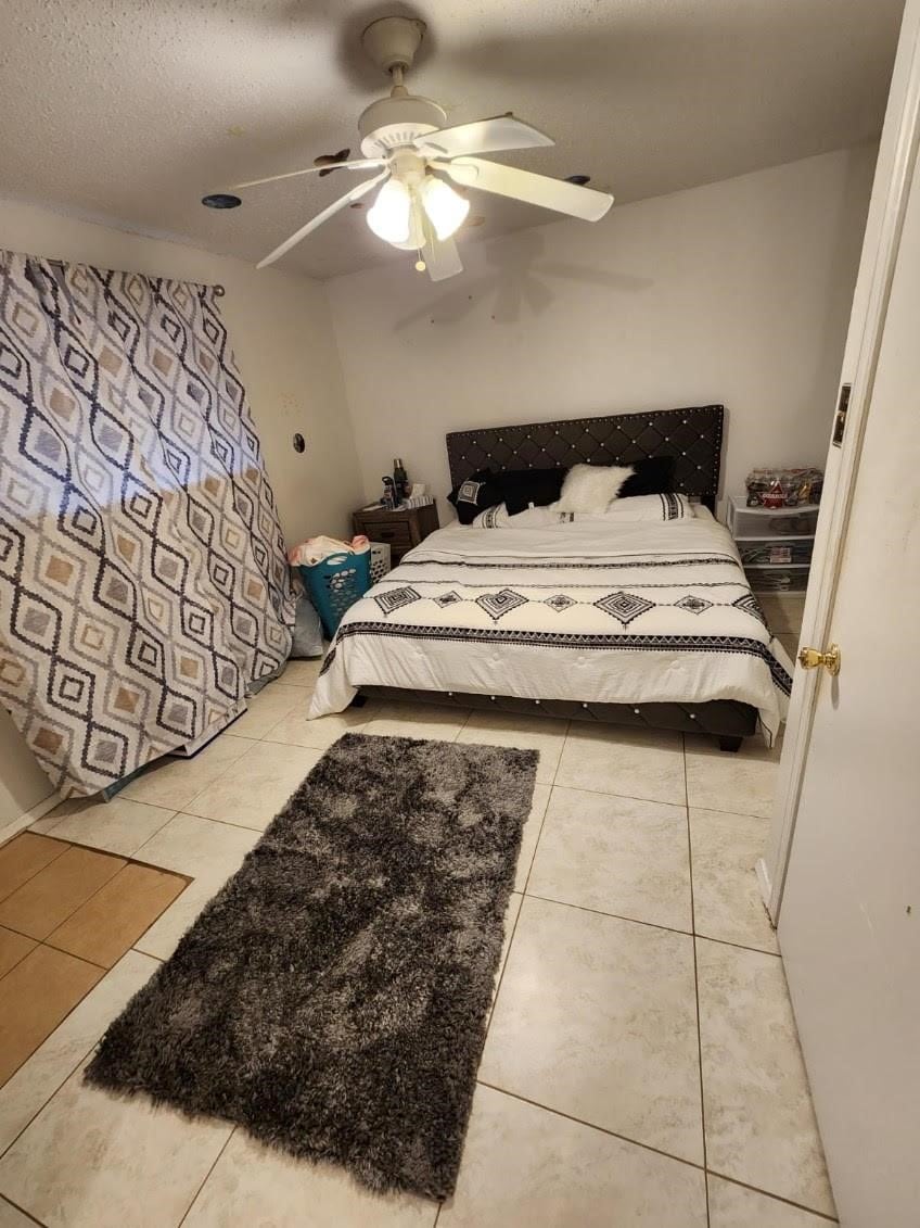 3624 Parkridge Dr Unit 213, Dallas, TX 75234 - bedroom featuring tile patterned floors and ceiling fan