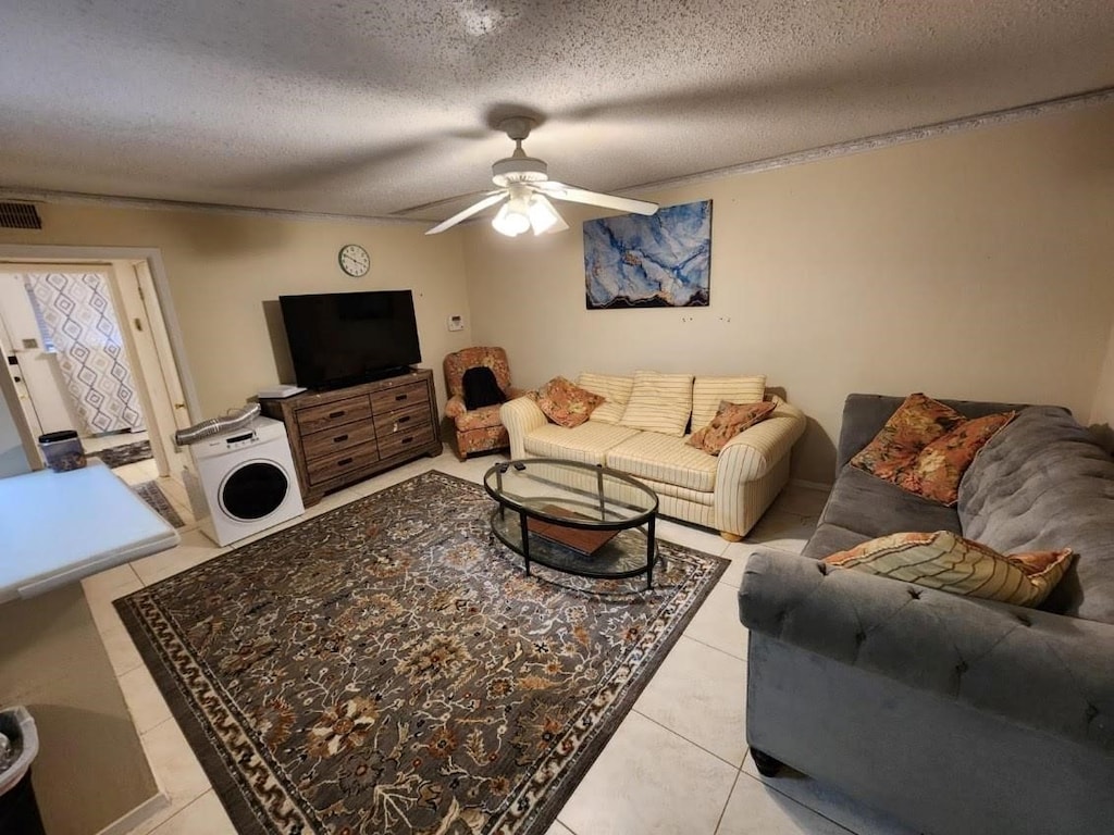 3624 Parkridge Dr Unit 213, Dallas, TX 75234 - living room featuring light tile patterned floors, a ceiling fan, and a textured ceiling