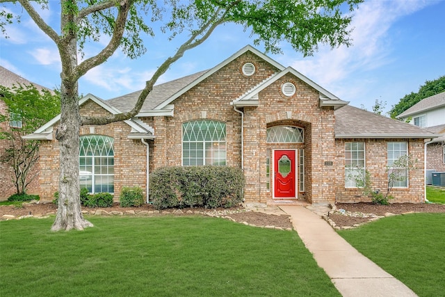 126 Oakbend Dr, Coppell, TX 75019 - traditional-style house with brick siding, a front lawn, roof with shingles, and central AC