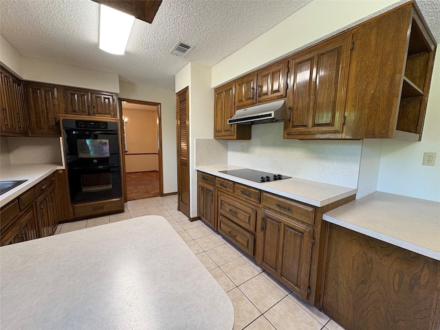 327 Shadowwood Trl, Ovilla, TX 75154 - kitchen with under cabinet range hood, black appliances, light countertops, open shelves, and light tile patterned floors