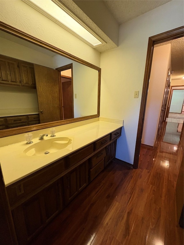 327 Shadowwood Trl, Ovilla, TX 75154 - bathroom with a textured ceiling, wood finished floors, and vanity