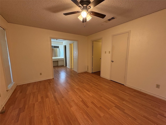 327 Shadowwood Trl, Ovilla, TX 75154 - spare room with wood finished floors, a textured ceiling, a ceiling fan, and baseboards