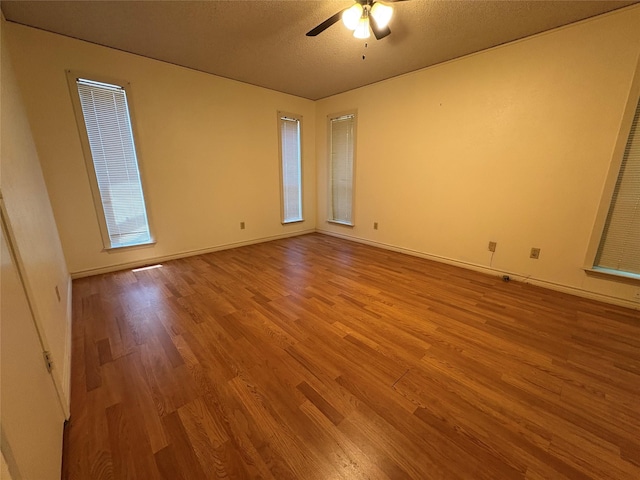 327 Shadowwood Trl, Ovilla, TX 75154 - empty room featuring wood finished floors, a ceiling fan, a textured ceiling, and baseboards
