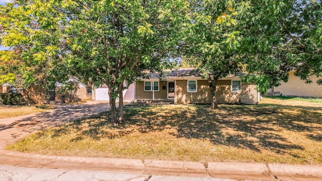7521 S College Cir, North Richland Hills, TX 76180 - view of front of house with concrete driveway, brick siding, and a front lawn