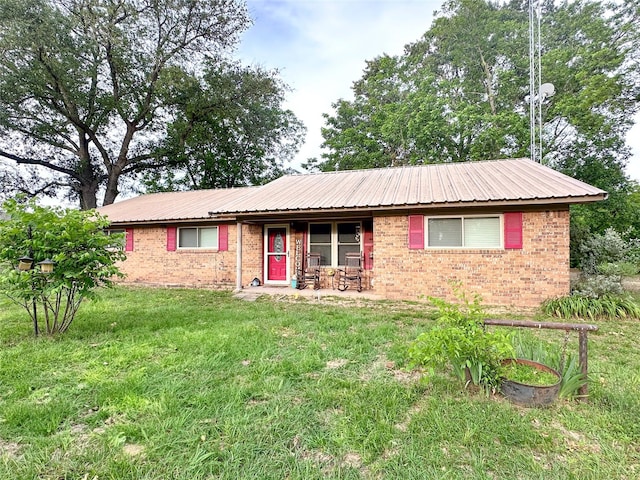 812 Walters St, Frankston, TX 75763 - ranch-style house featuring brick siding, a front lawn, metal roof, and covered porch