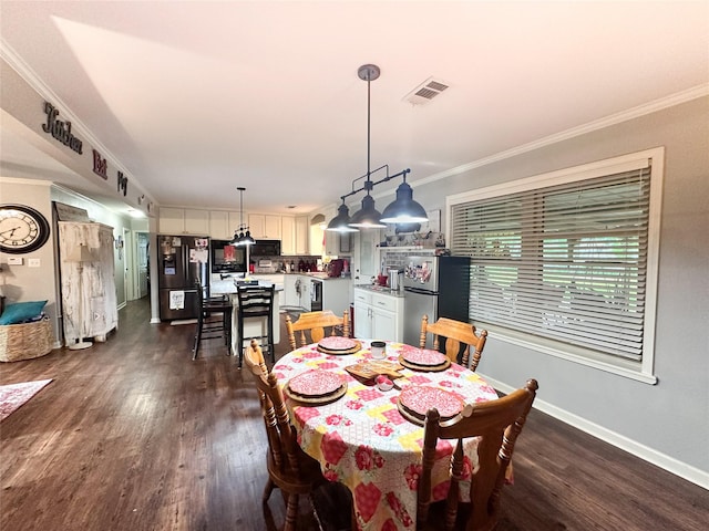 812 Walters St, Frankston, TX 75763 - dining area featuring dark wood finished floors, ornamental molding, and baseboards