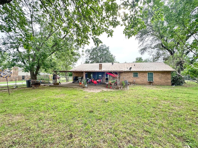 812 Walters St, Frankston, TX 75763 - back of house with metal roof and a patio area