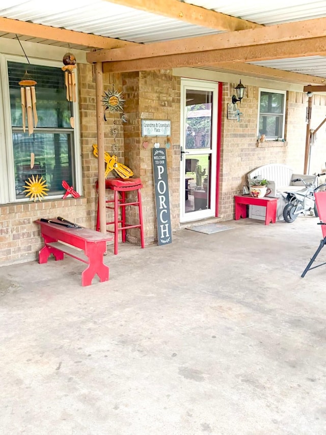 812 Walters St, Frankston, TX 75763 - view of exterior entry featuring brick siding and a porch