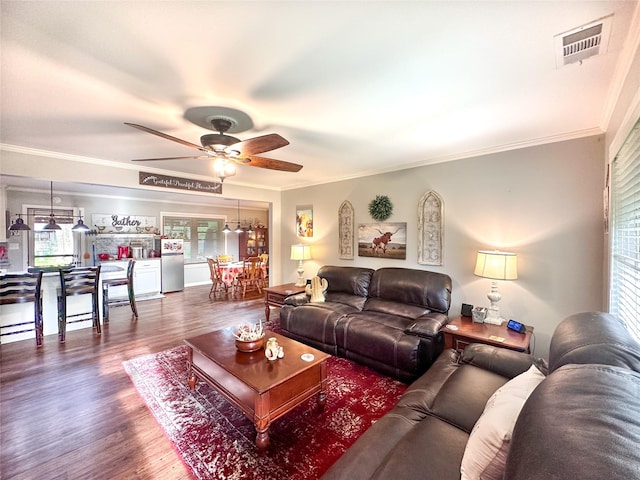 812 Walters St, Frankston, TX 75763 - living room with a ceiling fan, plenty of natural light, wood finished floors, and crown molding