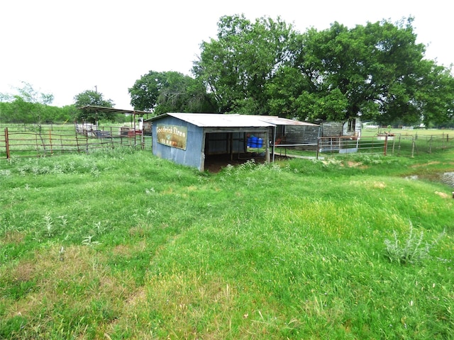 1075 County Road 436, Eastland, TX 76448 - view of yard featuring an outdoor structure, an exterior structure, a detached carport, and a view of countryside