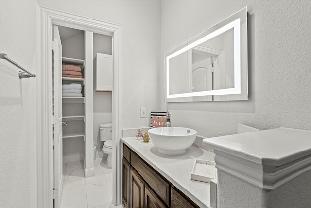 10643 Railswood Dr, Frisco, TX 75035 - bathroom with marble finish floors, toilet, and vanity