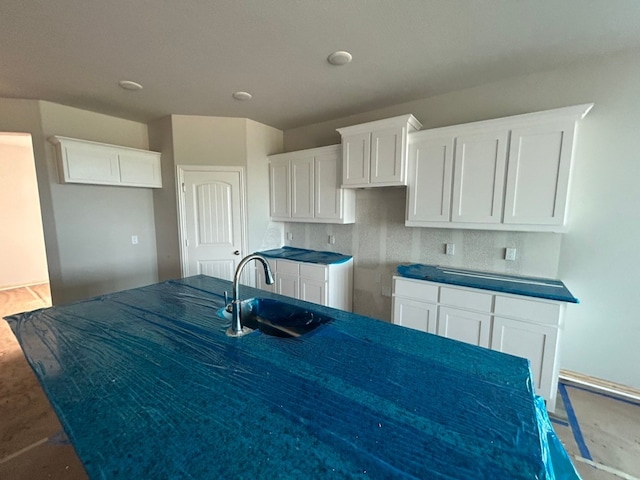 3514 Columbus St, Gainesville, TX 76240 - kitchen with a sink, white cabinetry, and dark countertops